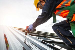 Homeowner examining roof shingles and attic rafters with a flashlight and inspection checklist KEYWORDS: ["roof inspection", "homeowner attic inspection", "roof shingles and gutters"]